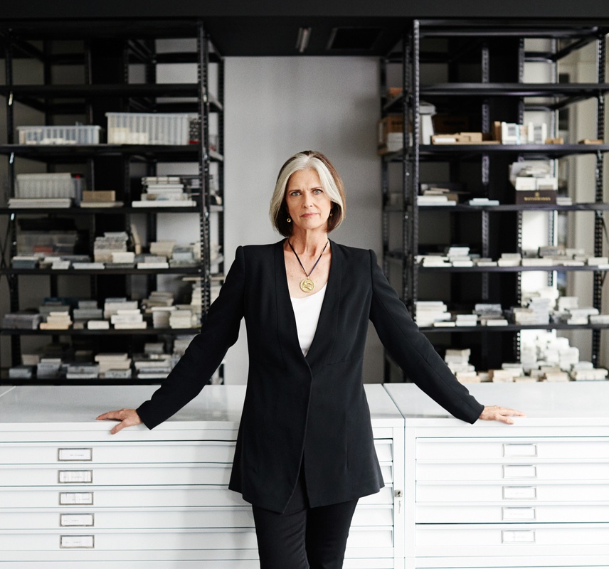 Portrait of Deborah Berke in office with file cabinets.